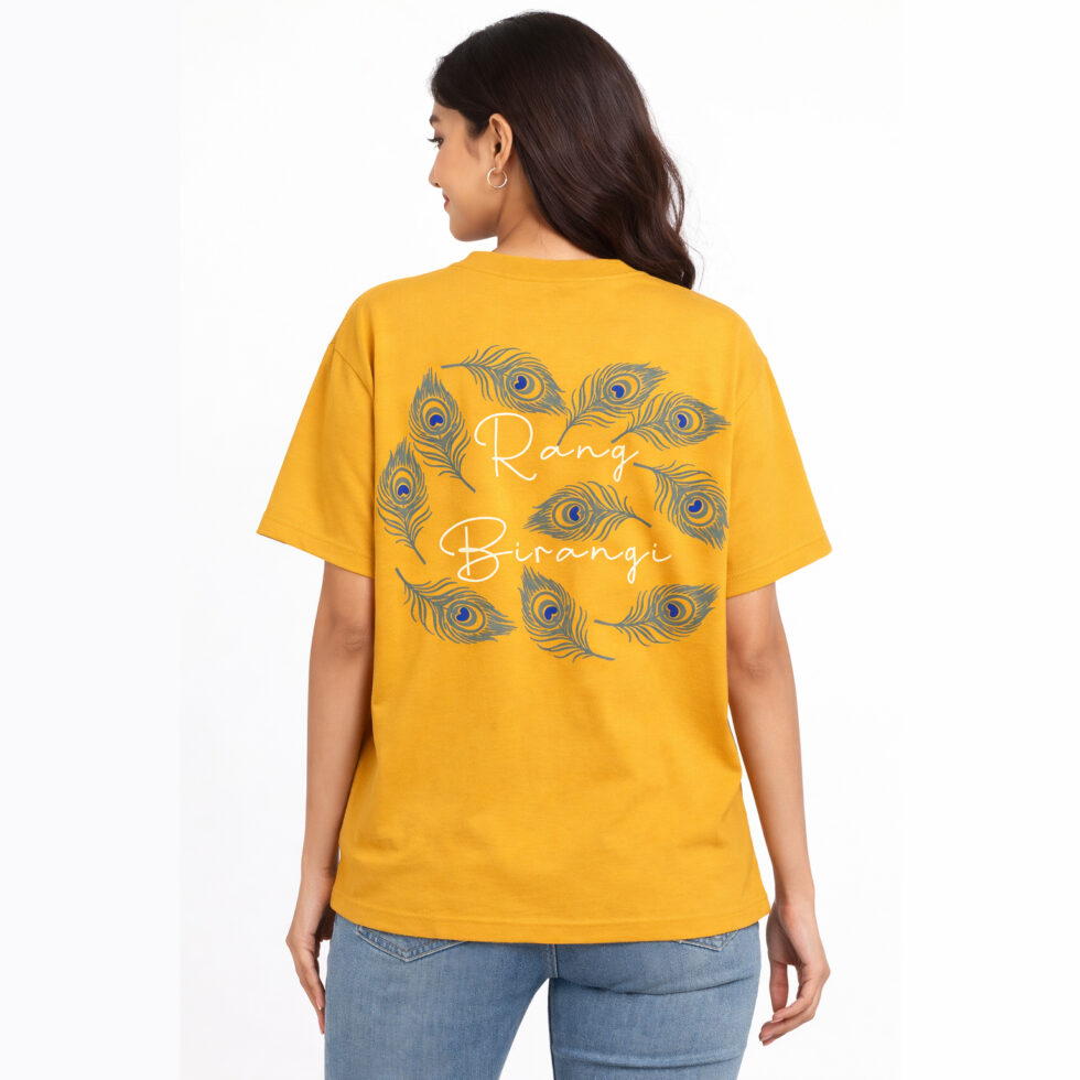 Back view of a mustard yellow oversized t-shirt featuring a circular arrangement of grey and blue peacock feathers with "Rang Birangi" written in white cursive text in the center.