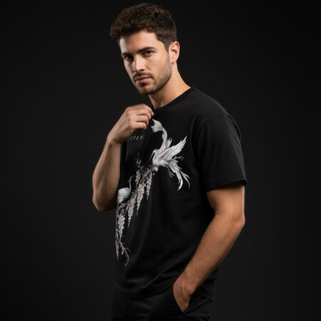 Front view of a black oversized graphic t-shirt featuring a detailed white hand-drawn illustration of two cranes perched on wisteria branches with the word 'ETHEREAL' in minimalist font.