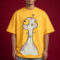 Front view of a male model wearing an oversized mustard yellow graphic t-shirt featuring a large whimsical cartoon character with pink spots and purple hearts.