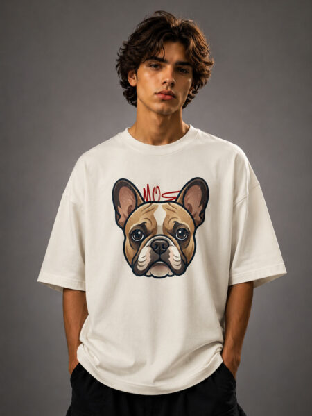 Front view of a male model wearing a cream-colored drop shoulder t-shirt with a detailed French Bulldog face graphic print on the chest