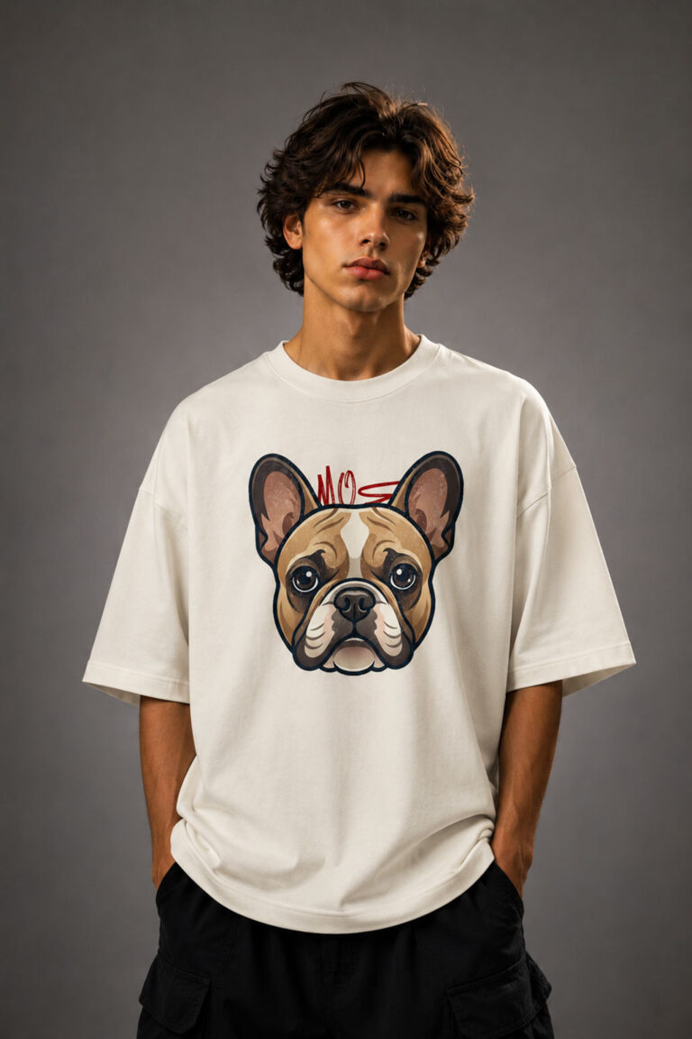 Front view of a male model wearing a cream-colored drop shoulder t-shirt with a detailed French Bulldog face graphic print on the chest
