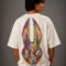 Oversized white MOS graphic t-shirt featuring a colorful abstract rabbit mask design on the front chest and a large vibrant hand-drawn rabbit illustration on the back, styled on a fashion model in a modern streetwear photoshoot.