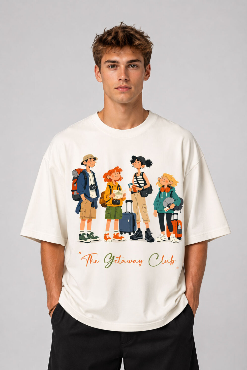 Front view of a man wearing The Getaway Club cream oversized graphic t-shirt featuring a colorful travel-themed character illustration across the chest.