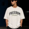 Freedom Dreamer oversized cotton graphic t-shirt for men featuring vintage moth artwork on the back and bold typography on premium off-white oversized streetwear tee